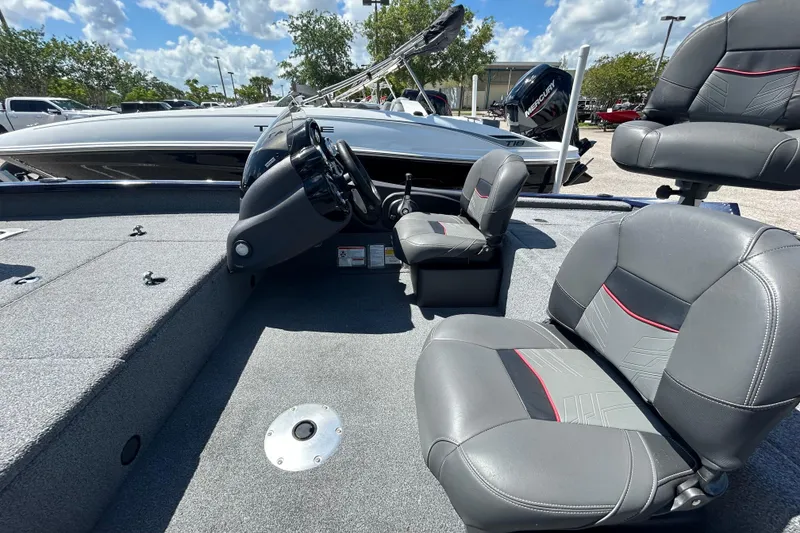Slide: The Image of 2021 Tracker Pro Team 175 TF boat interior with gray seating and steering console. - 7