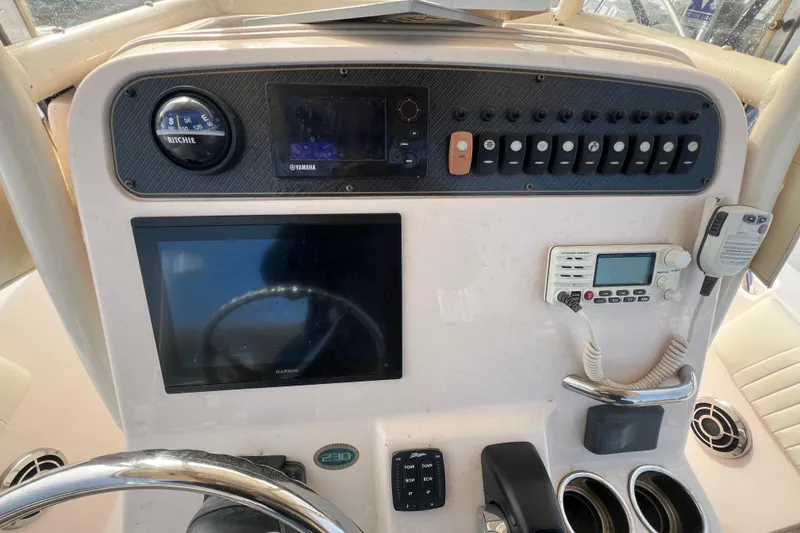 Slide: The Image of 2014 Grady-White Fisherman 230 dashboard with navigation and control systems. - 10