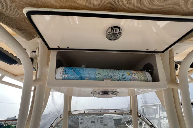 Slide: The Image of Storage compartment on a 2014 Grady-White Fisherman 230 boat with a rolled nautical chart. - 11