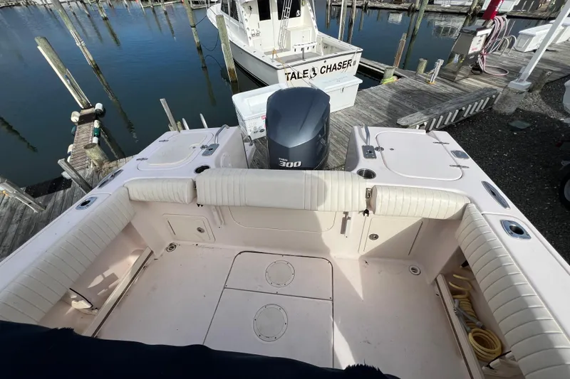 Slide: The Image of 2014 Grady-White Fisherman 230 boat interior with Yamaha 300 engine at dock. - 12