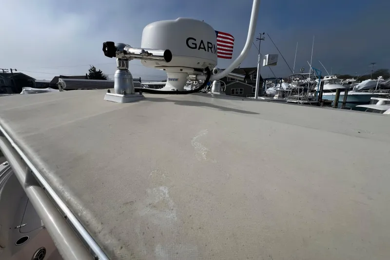 Slide: The Image of 2014 Grady-White Fisherman 230 boat with radar equipment on deck, docked at marina. - 13