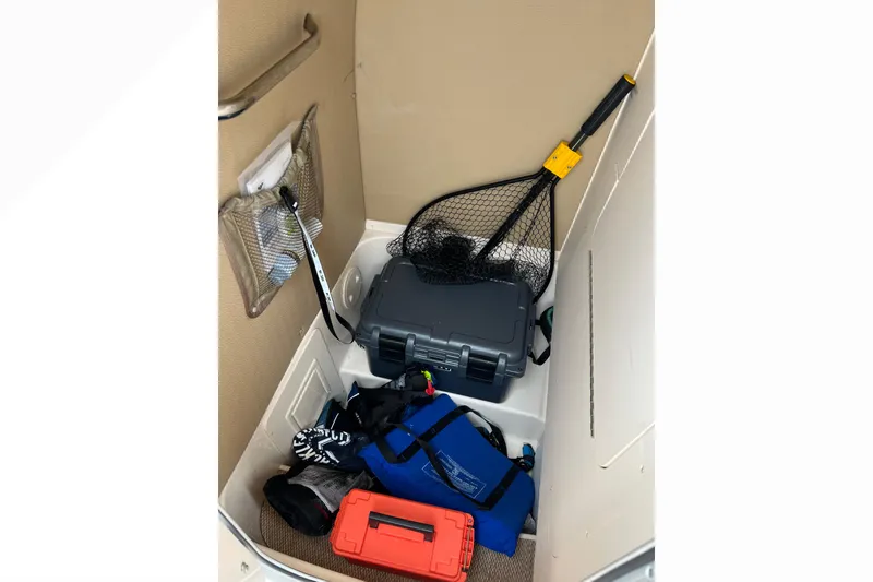 Slide: The Image of Storage area in a 2014 Grady-White Fisherman 230 boat with fishing gear and equipment. - 14