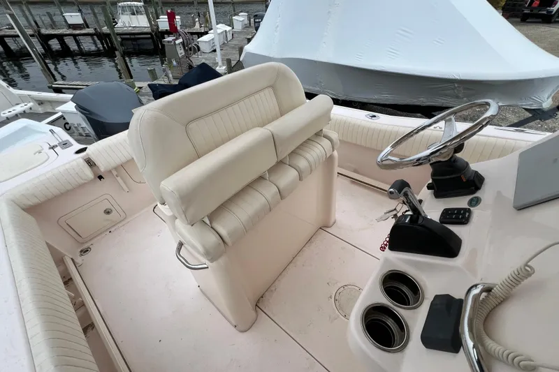 Slide: The Image of 2014 Grady-White Fisherman 230 boat interior with helm, seating, and controls. - 16