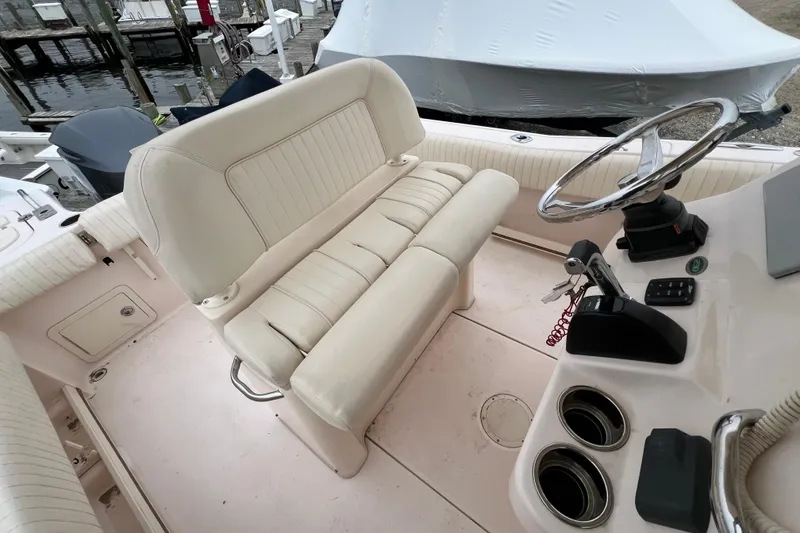 Slide: The Image of 2014 Grady-White Fisherman 230 boat interior with steering wheel and seating. - 17