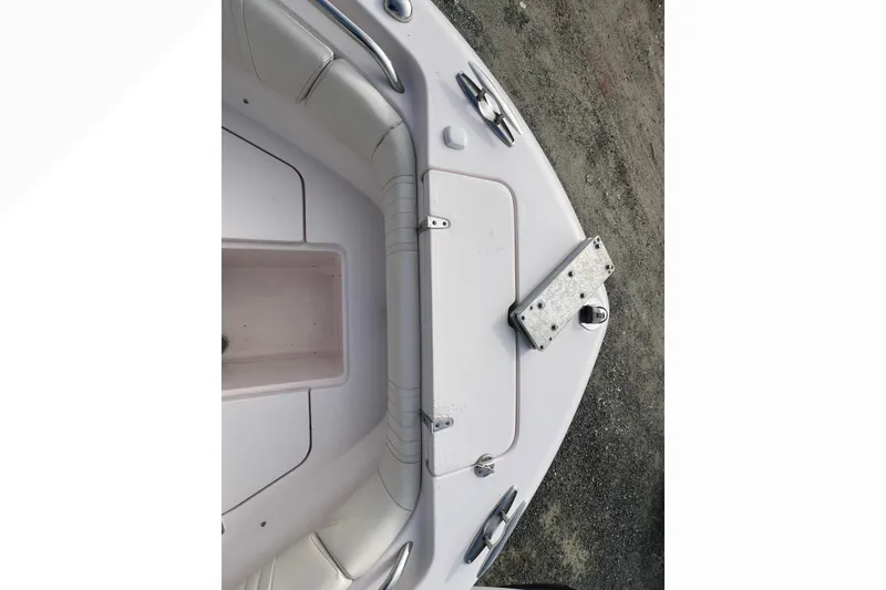 Slide: The Image of 2014 Grady-White Fisherman 230 boat deck, featuring storage compartment and cleats. - 6