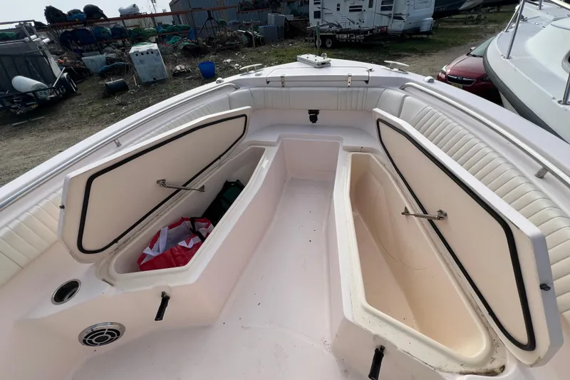 Slide: The Image of 2014 Grady-White Fisherman 230 boat with open storage compartments on deck. - 8