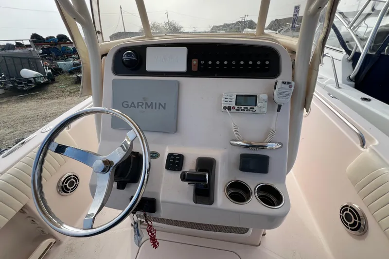 Slide: The Image of 2014 Grady-White Fisherman 230 boat console with Garmin navigation and steering wheel. - 9