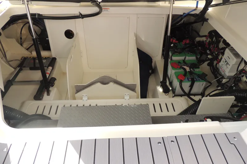Slide: The Image of Engine compartment of 2020 Sea Ray Sundancer 320 Outboard with visible batteries and wiring. - 17
