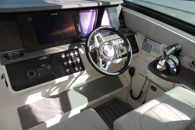Slide: The Image of Cockpit of 2020 Sea Ray Sundancer 320 Outboard with modern controls and steering wheel. - 24