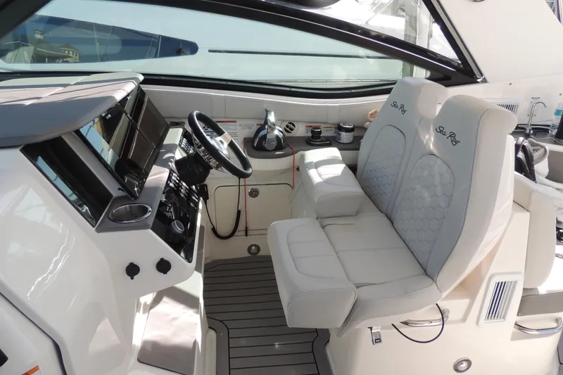Slide: The Image of 2020 Sea Ray Sundancer 320 Outboard cockpit with dual seats and modern dashboard controls. - 25