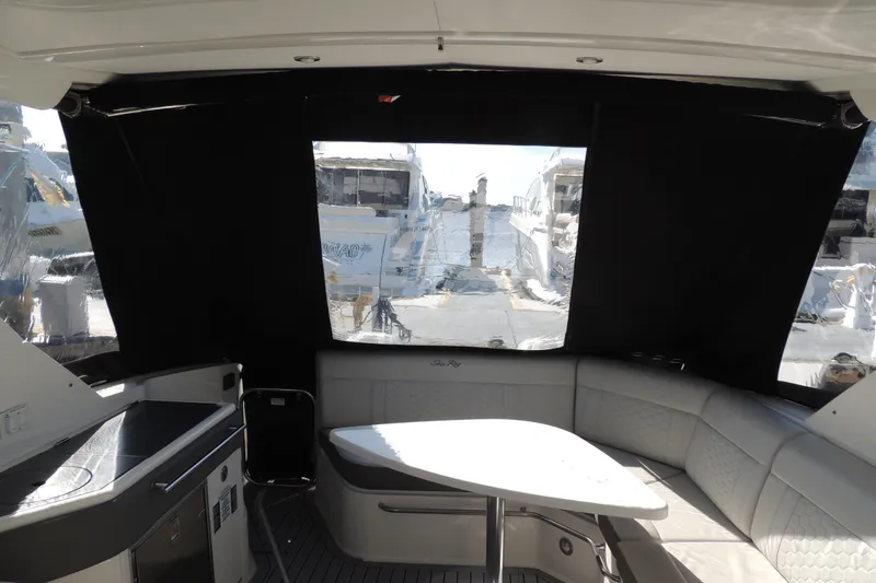 Slide: The Image of Interior view of 2020 Sea Ray Sundancer 320 Outboard, featuring seating and table. - 4