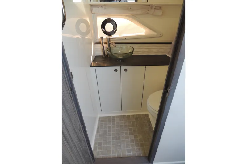Slide: The Image of 2020 Sea Ray Sundancer 320 Outboard bathroom with modern sink and compact design. - 5