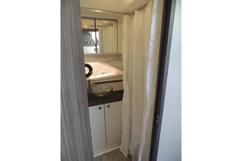 Slide: The Image of 2020 Sea Ray Sundancer 320 Outboard bathroom with modern sink and shower curtain. - 6