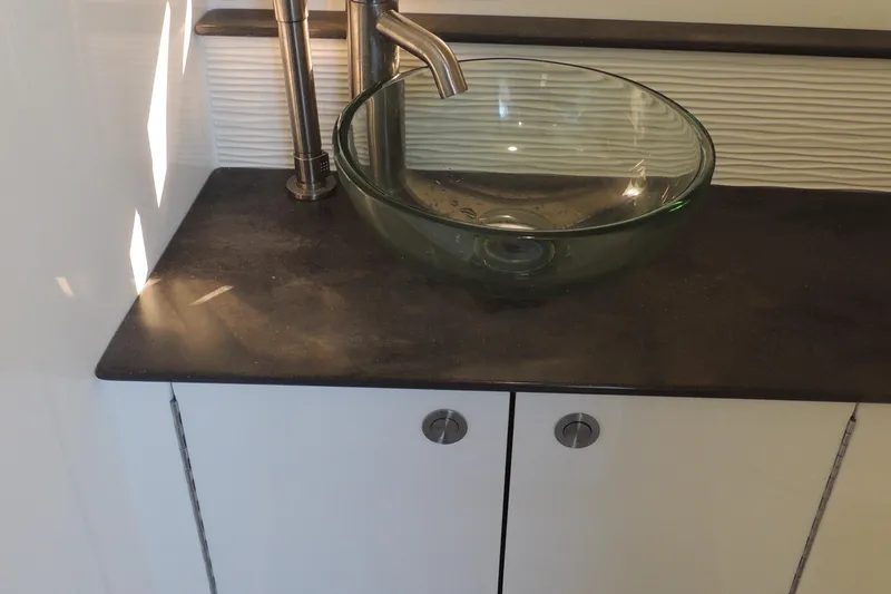 Slide: The Image of Glass sink on black countertop in 2020 Sea Ray Sundancer 320 Outboard. - 7