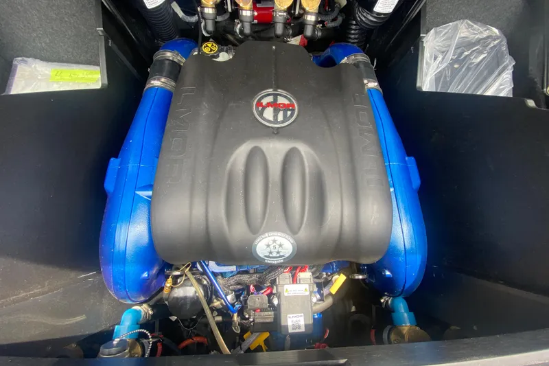 Slide: The Image of 2021 MasterCraft X26 engine compartment with Ilmor engine, showcasing blue and black components. - 13