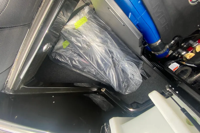 Slide: The Image of 2021 MasterCraft X26 engine compartment with wrapped components and visible blue engine parts. - 15