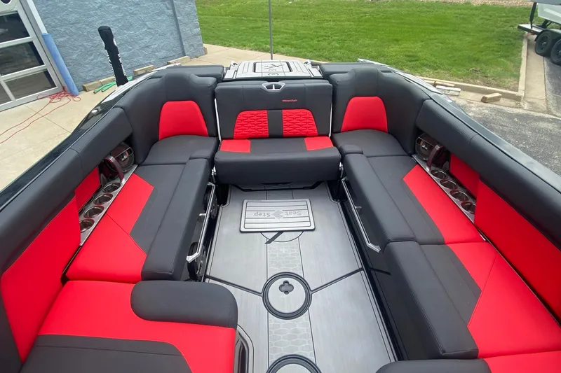 Slide: The Image of 2021 MasterCraft X26 boat interior with red and black seating, showcasing luxury and style. - 17