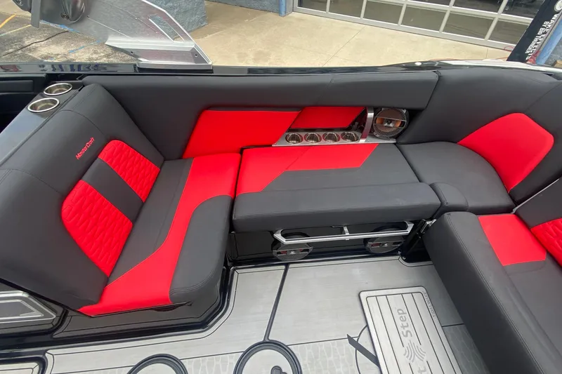 Slide: The Image of 2021 MasterCraft X26 interior with red and black seating, cup holders, and speakers. - 18