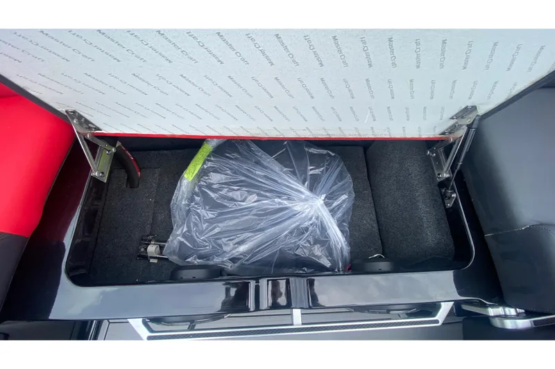 Slide: The Image of Storage compartment of 2021 MasterCraft X26 boat, featuring organized interior space. - 19