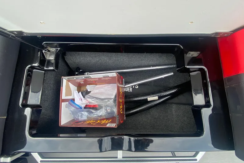Slide: The Image of Storage compartment of 2021 MasterCraft X26 boat with accessories and manual. - 23