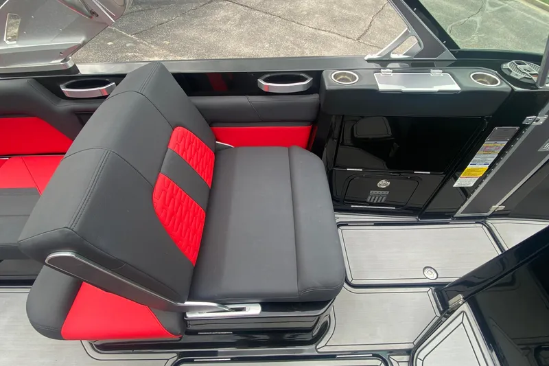 Slide: The Image of 2021 MasterCraft X26 interior with black and red seating, cup holders, and sleek design. - 25