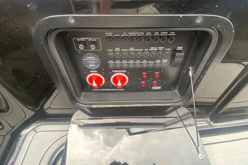 Slide: The Image of Control panel of a 2021 MasterCraft X26 boat with various switches and indicators. - 26