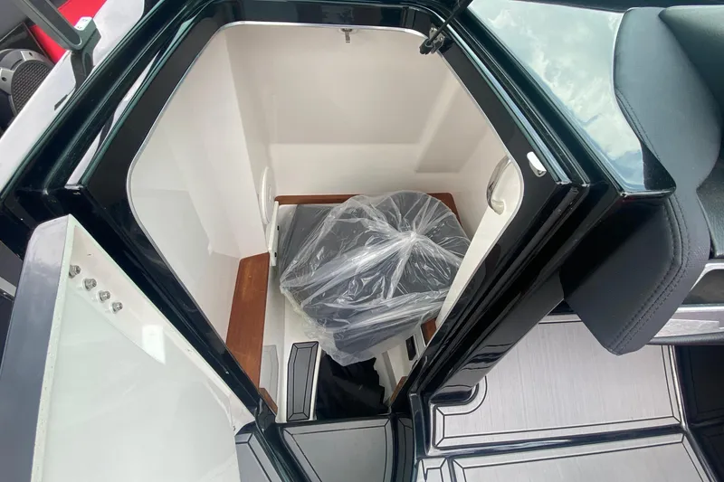 Slide: The Image of 2021 MasterCraft X26 boat interior storage compartment with sleek design and modern features. - 28