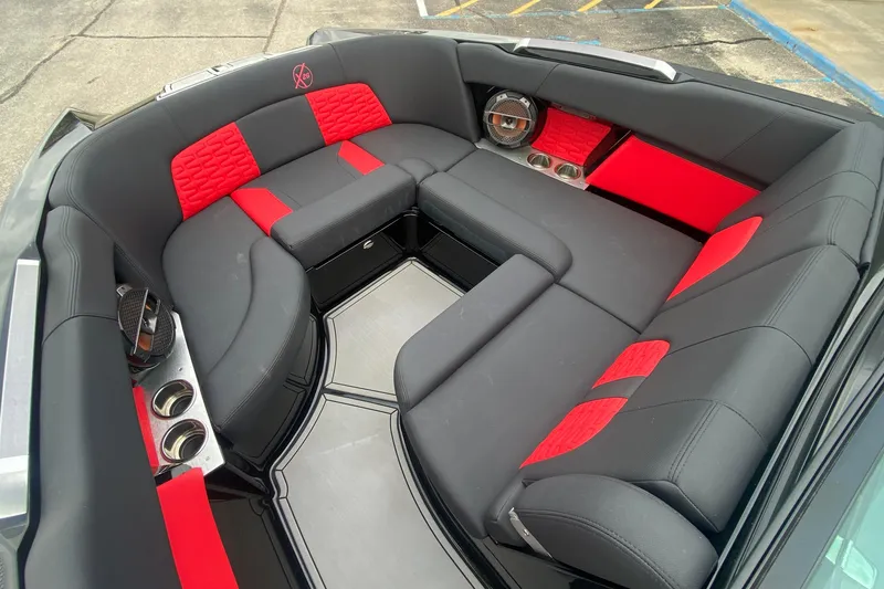 Slide: The Image of Luxurious 2021 MasterCraft X26 boat interior with red and black seating and cup holders. - 30