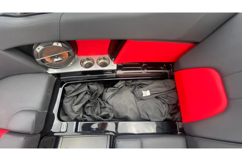 Slide: The Image of Interior of 2021 MasterCraft X26 boat with speaker, cup holders, and storage compartment. - 31