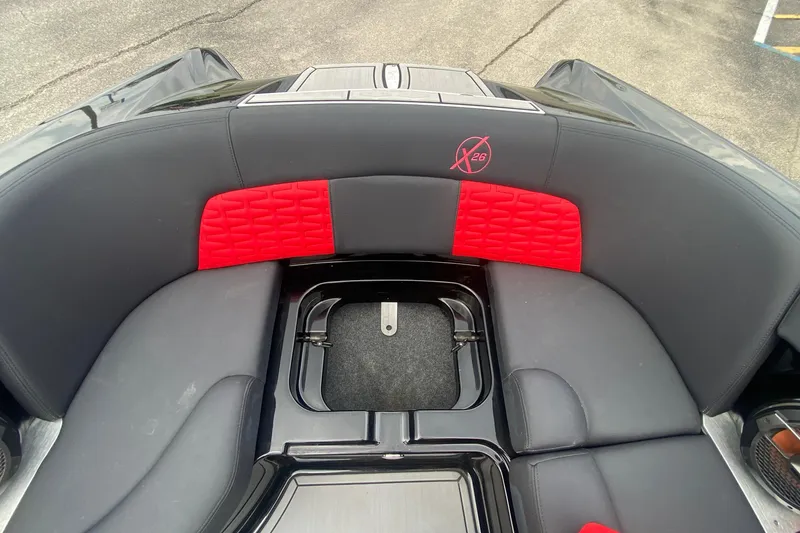Slide: The Image of 2021 MasterCraft X26 boat interior with black and red seating design. - 32