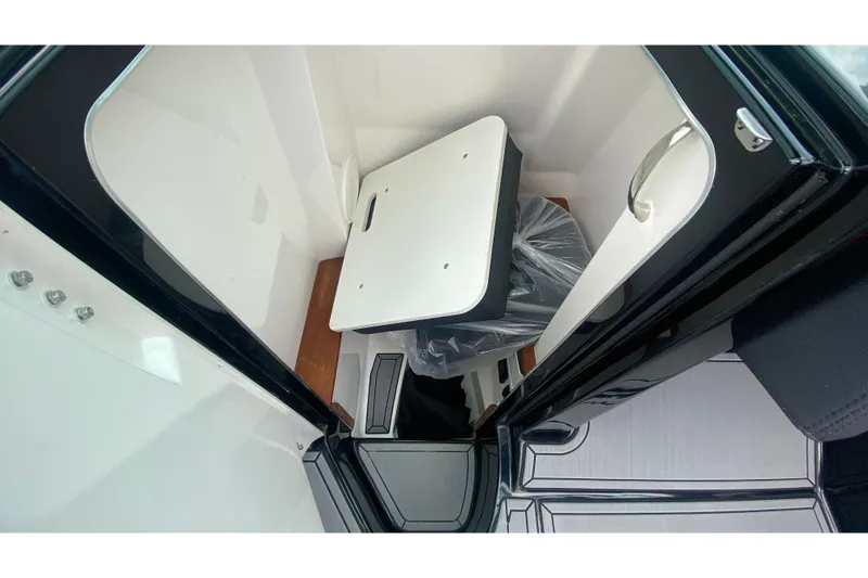 Slide: The Image of 2021 MasterCraft X26 interior storage compartment with white and black accents. - 33