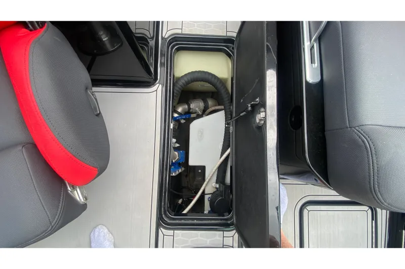 Slide: The Image of Interior view of a 2021 MasterCraft X26 boat compartment with seating and storage. - 34
