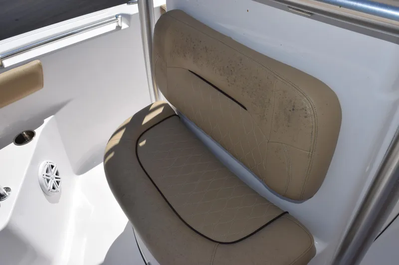 Slide: The Image of 2019 Sportsman Open 212 Center Console boat seat with beige upholstery and speaker. - 11