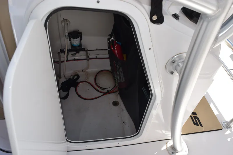 Slide: The Image of 2019 Sportsman Open 212 Center Console storage compartment with wiring and equipment. - 13