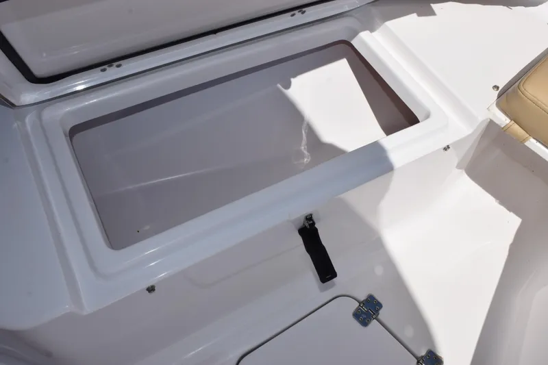 Slide: The Image of Open storage compartment on a 2019 Sportsman Open 212 Center Console boat. - 15