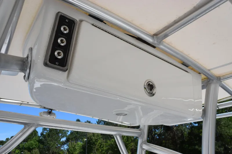 Slide: The Image of 2019 Sportsman Open 212 Center Console T-top storage compartment with control panel. - 18