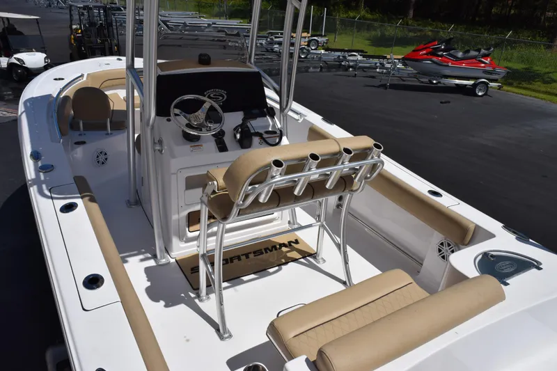 Slide: The Image of 2019 Sportsman Open 212 Center Console boat with beige seating and fishing rod holders. - 6