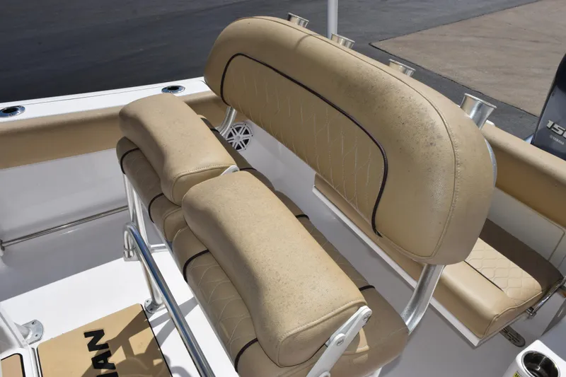 Slide: The Image of 2019 Sportsman Open 212 Center Console boat with tan cushioned seating and rod holders. - 8