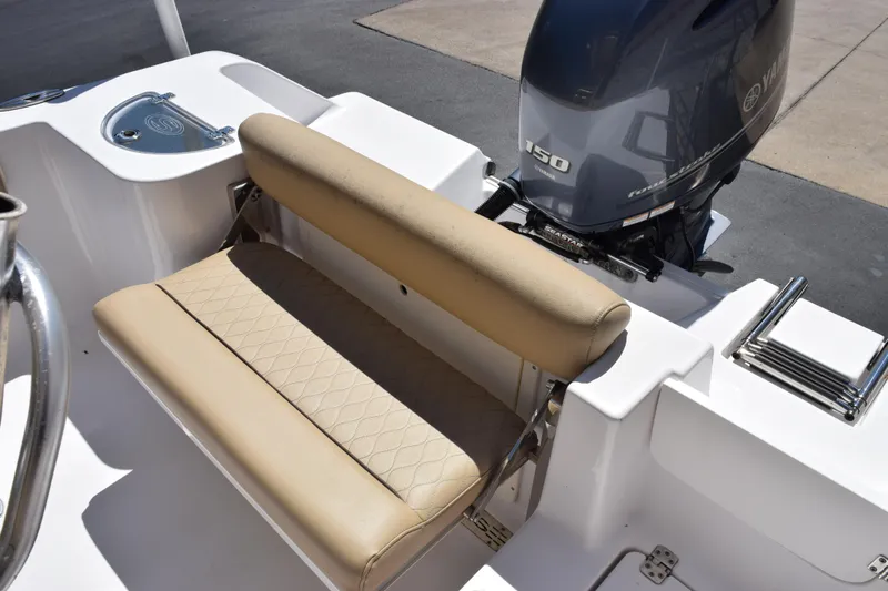 Slide: The Image of 2019 Sportsman Open 212 Center Console boat with Yamaha 150 engine and beige seating. - 9