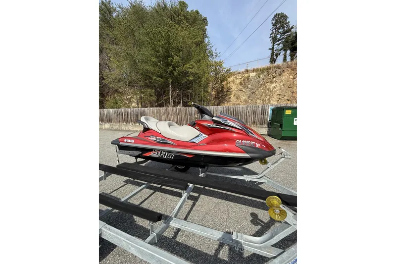 The Image of 2009 Yamaha WaveRunner FX SHO in red on a trailer, parked outdoors. - 2