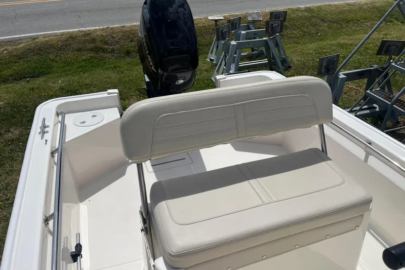 Slide: The Image of 2021 Boston Whaler 150 Montauk boat interior with seating and motor. - 10