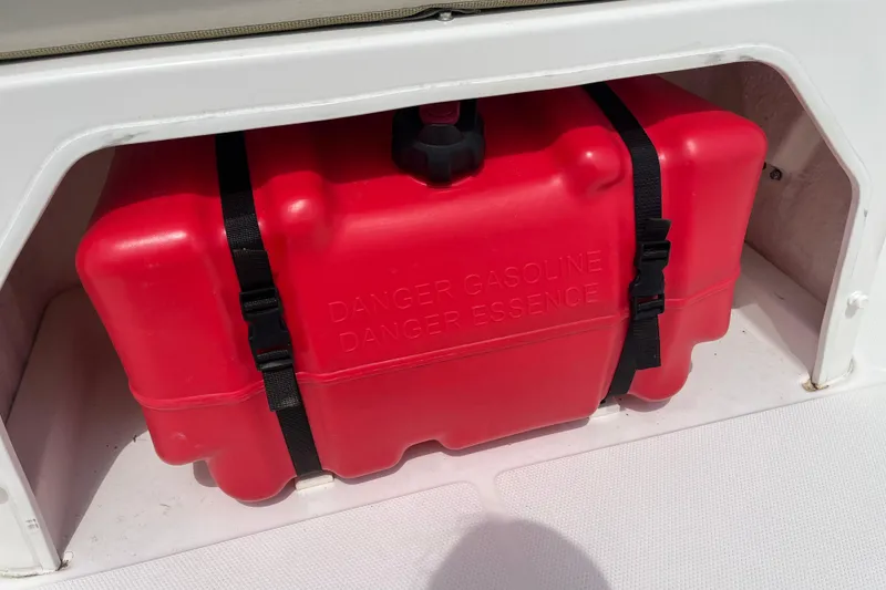 Slide: The Image of Red gasoline tank secured in a 2021 Boston Whaler 150 Montauk boat compartment. - 12