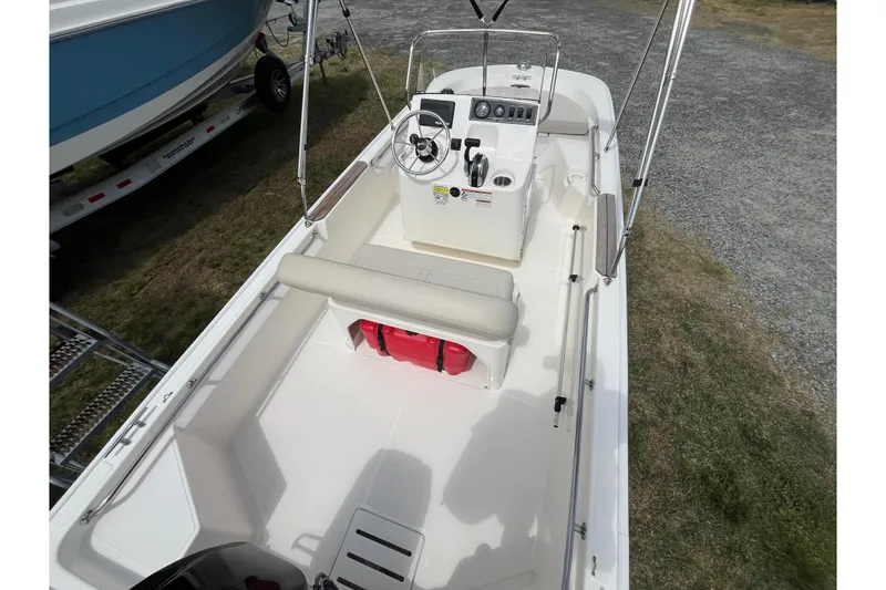 Slide: The Image of 2021 Boston Whaler 150 Montauk boat interior with steering console and seating. - 15