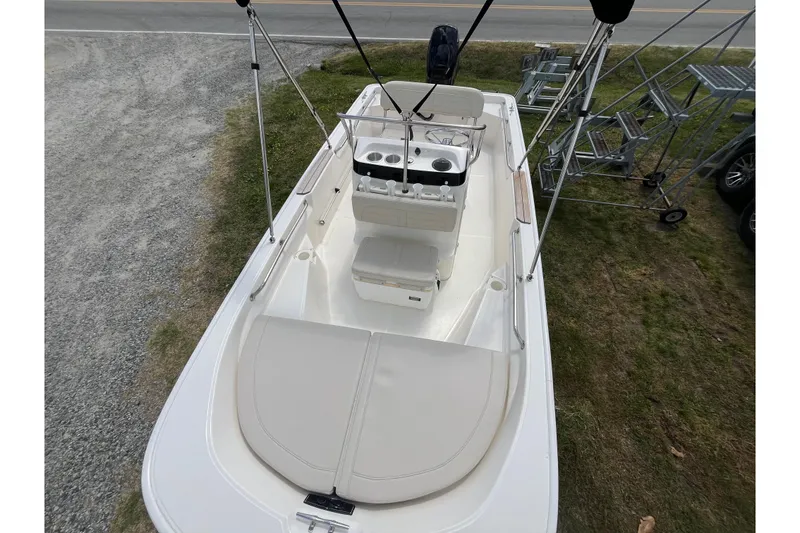 Slide: The Image of 2021 Boston Whaler 150 Montauk boat, top view, showcasing seating and console layout. - 2