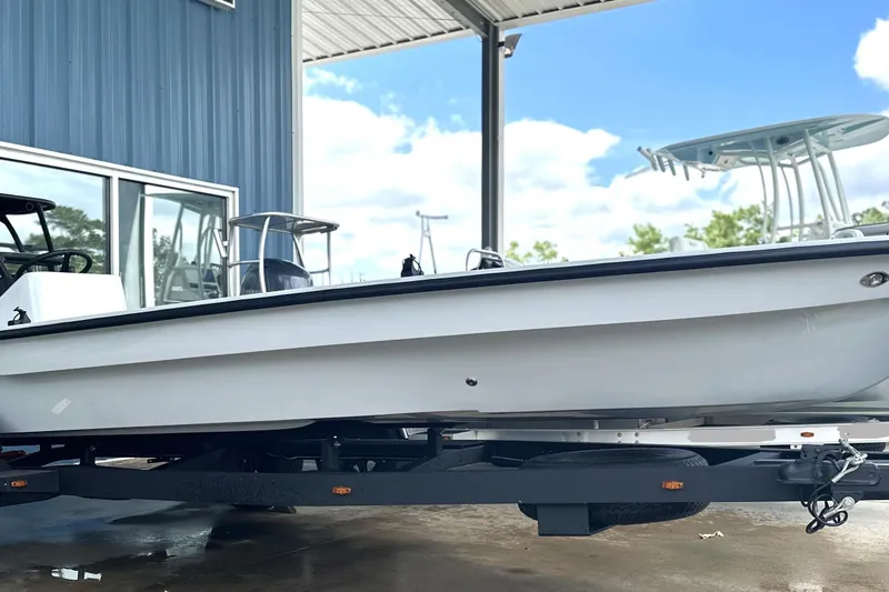 The Image of 2026 Chittum Skiffs 18 Challenger 2.0 boat on trailer, parked outdoors. - 0