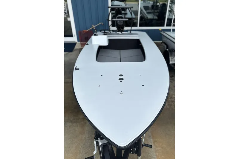 Slide: The Image of 2026 Chittum Skiffs 18 Challenger 2.0 boat, sleek design, docked outdoors. - 27