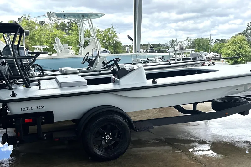 Slide: The Image of 2026 Chittum Skiffs 18 Challenger 2.0 on trailer, parked outdoors under cloudy sky. - 29