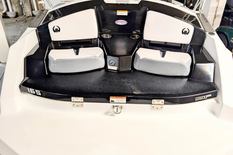 Slide: The Image of 2023 Scarab 165 ID boat interior with seating and Rotax engine branding. - 5