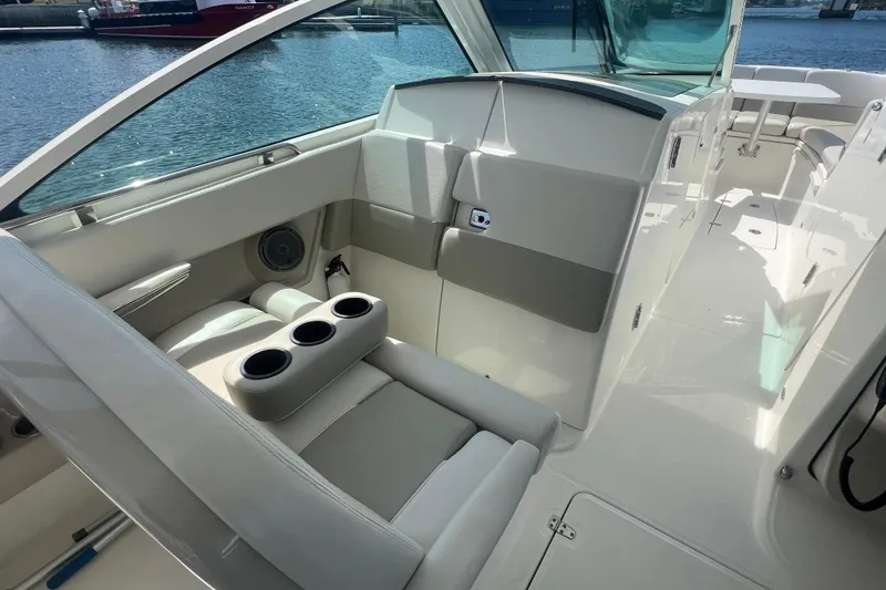 Slide: The Image of Interior of a 2015 Boston Whaler 320 Vantage boat with seating and cup holders. - 11