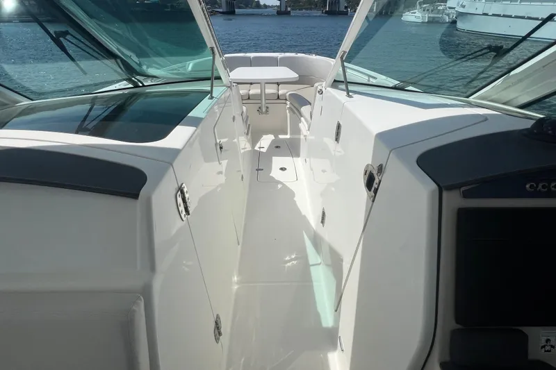 Slide: The Image of 2015 Boston Whaler 320 Vantage boat interior with seating and water view. - 12